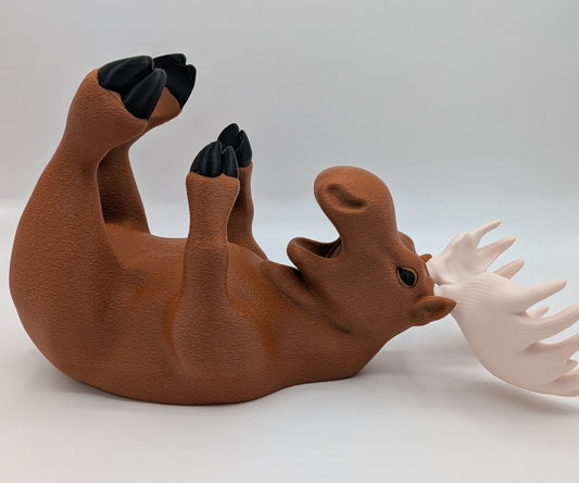 Charming 3D printed moose wine holder in a relaxed position, adding whimsy to home decor.