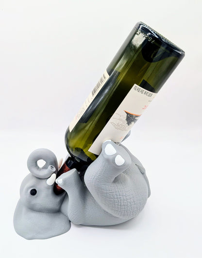 Charming gray elephant wine holder in a playful reclining position, perfect for unique home decor.