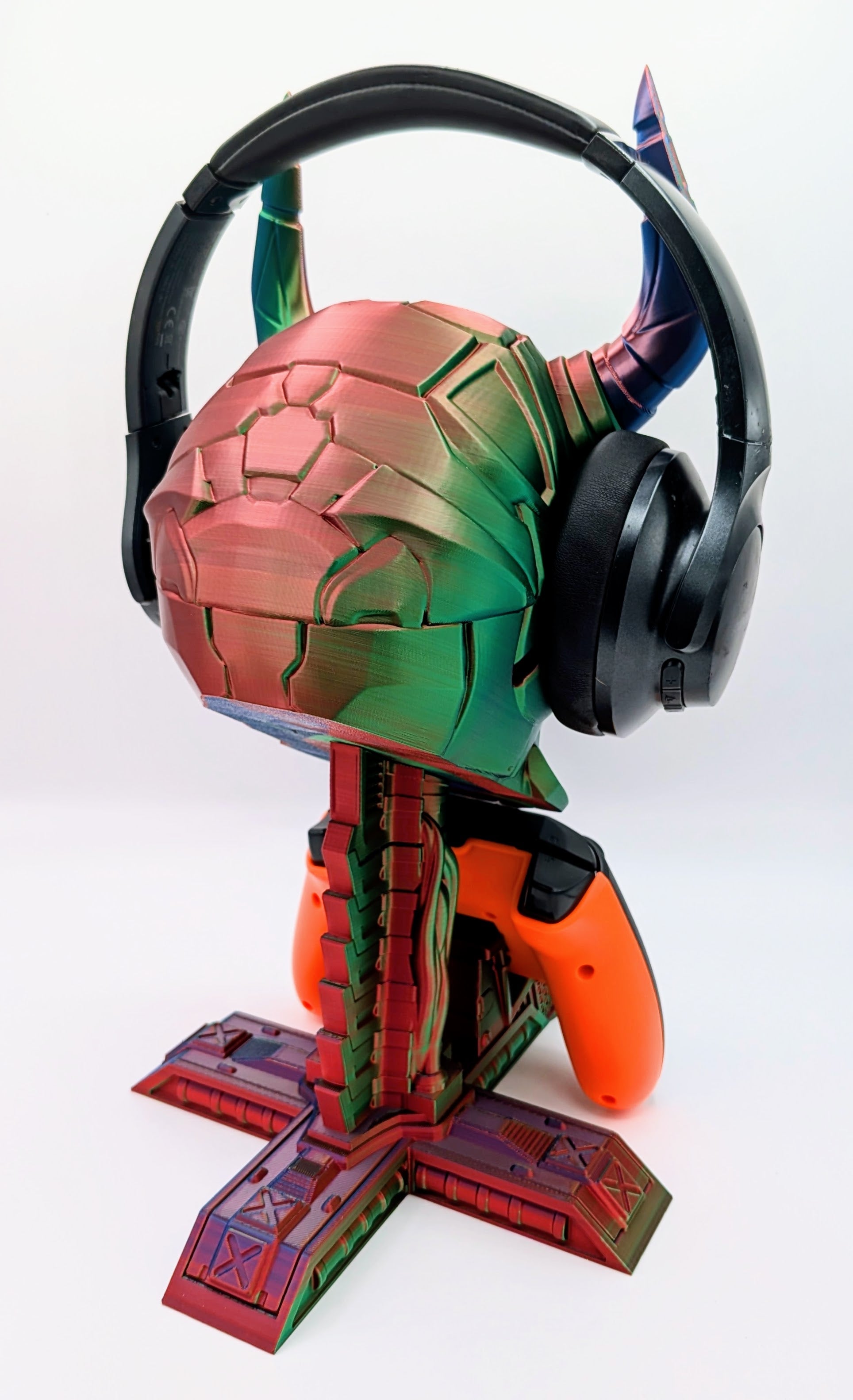 Colorful demon skull display with headphones and game controller, perfect for gamers and collectors.